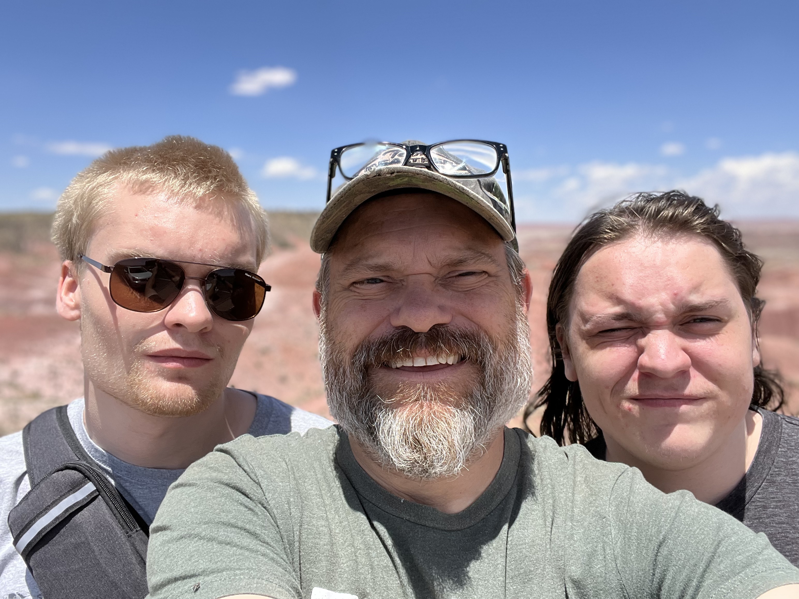Scott Shellabarger and his two sons smiling outdoors